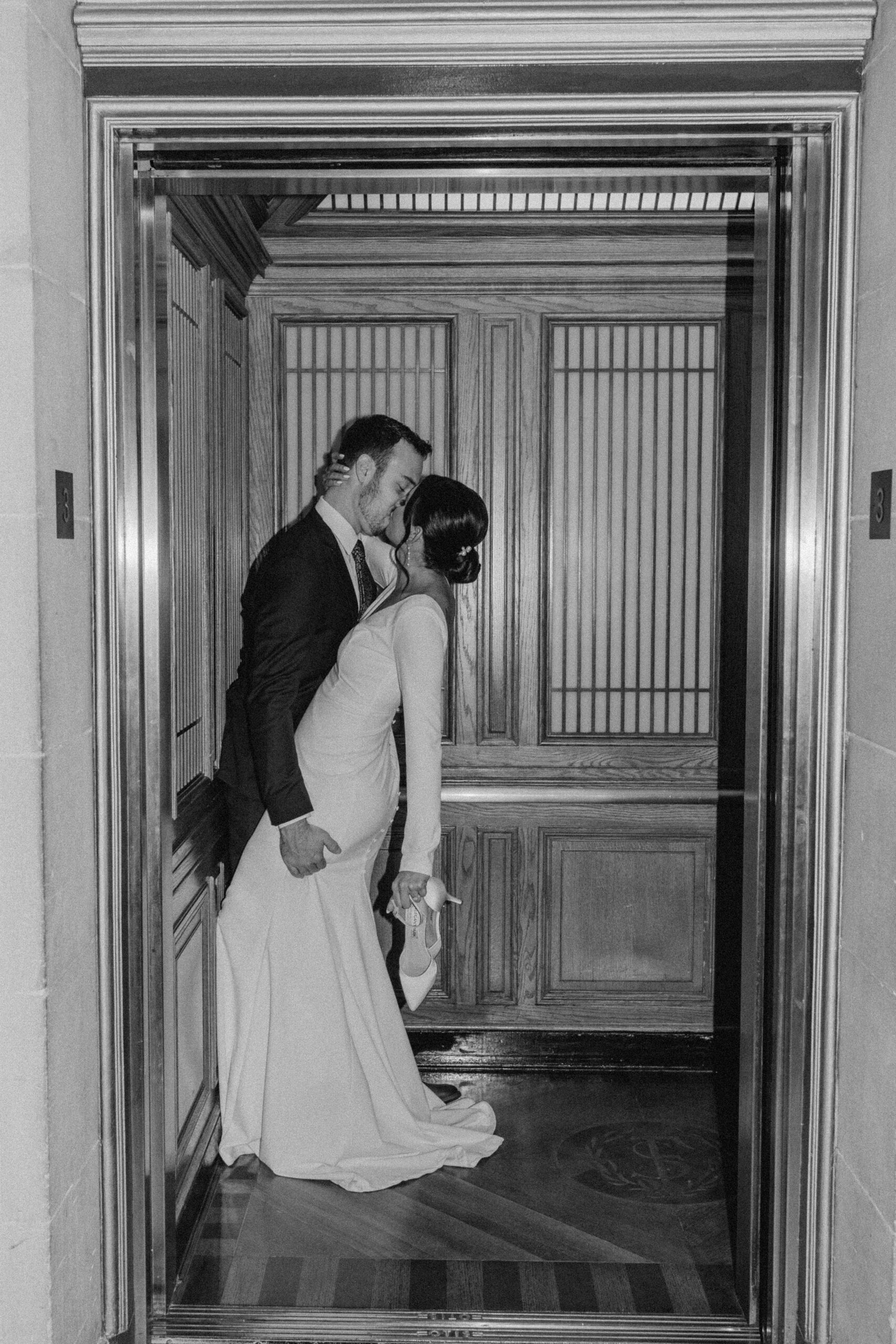 couple kissing as elevator closes in San Francisco City Hall