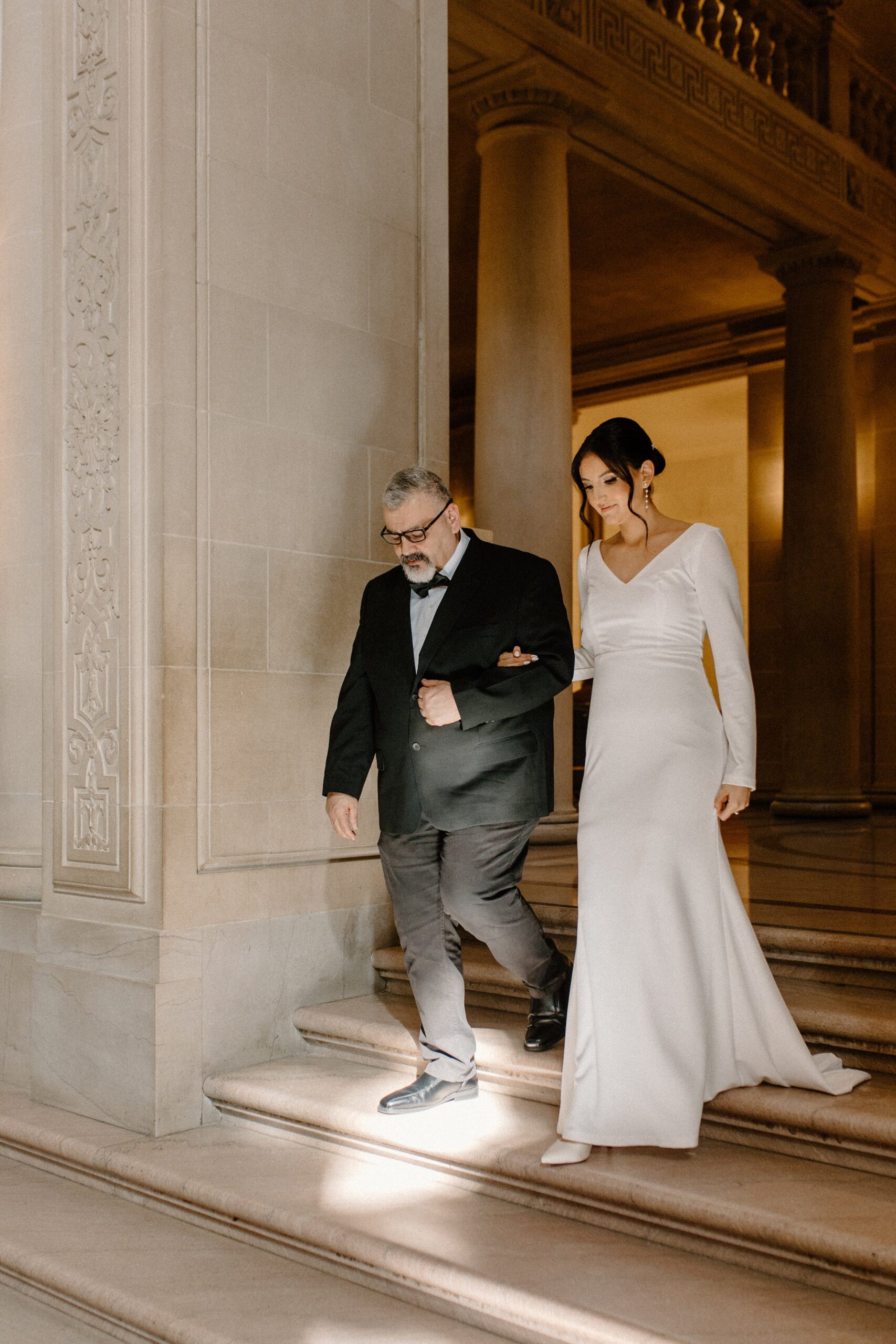 Father walking Daughter down the stairs of the aisle at her Elopement at San Francisco City Hall