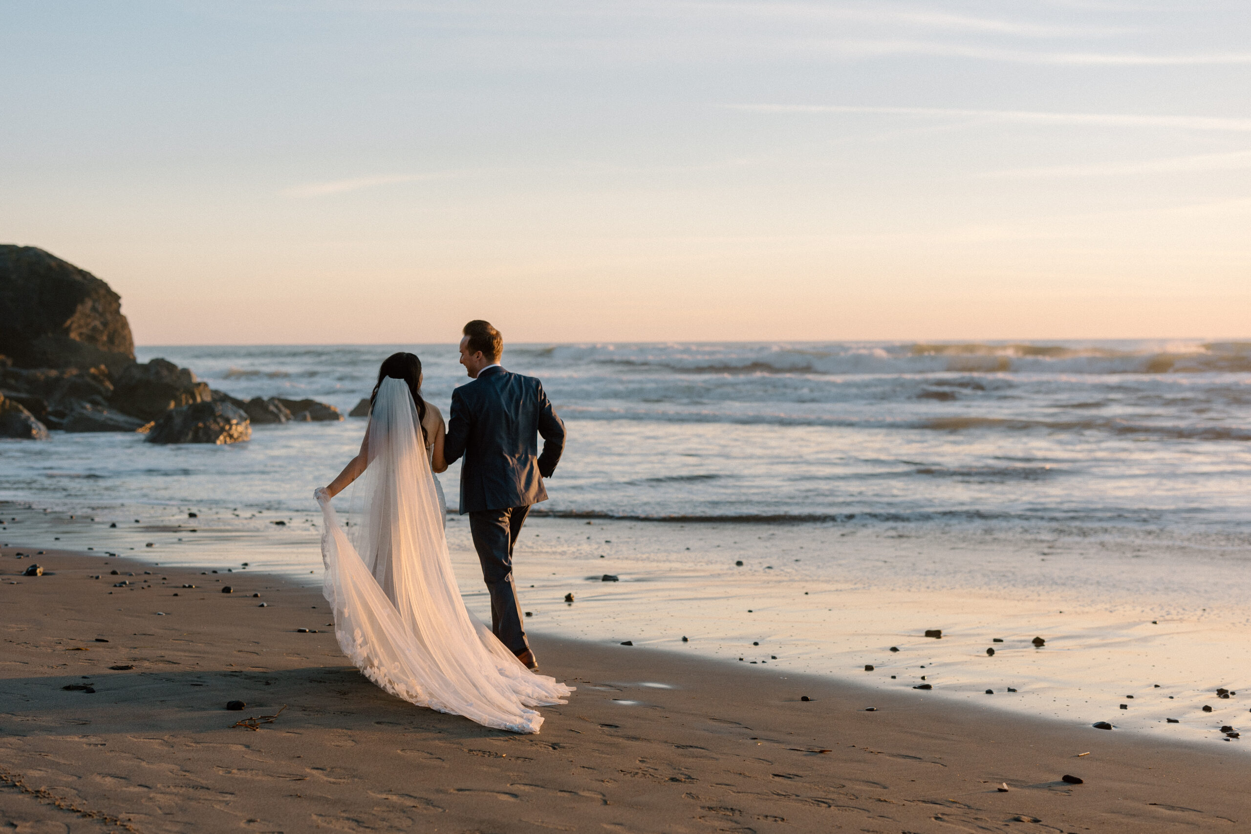 Stinson beach elopement couple at sunset in their wedding clothes, wedding dress