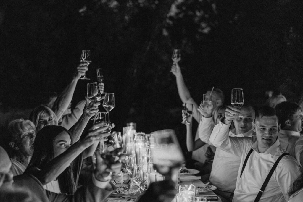 California wedding reception with glasses raised for the bride and groom, black and white classic photo