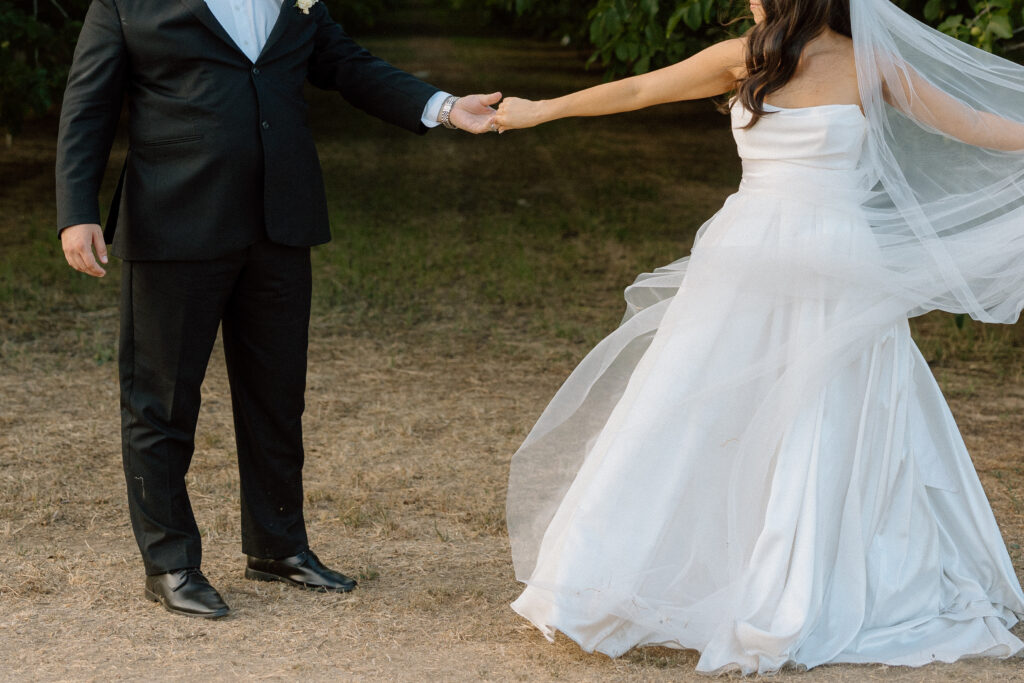 Twirl of wedding couple with veil spinning around wedding dress