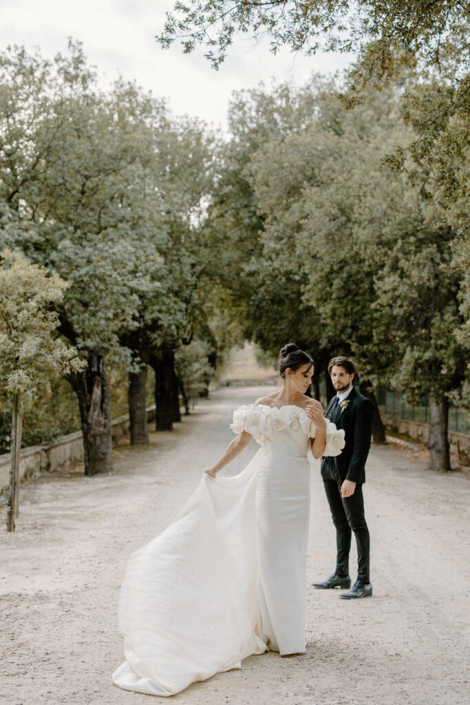 Wedding couple surrounded by Italian cypresses trees at Villa Corsini in Tuscany, Italy