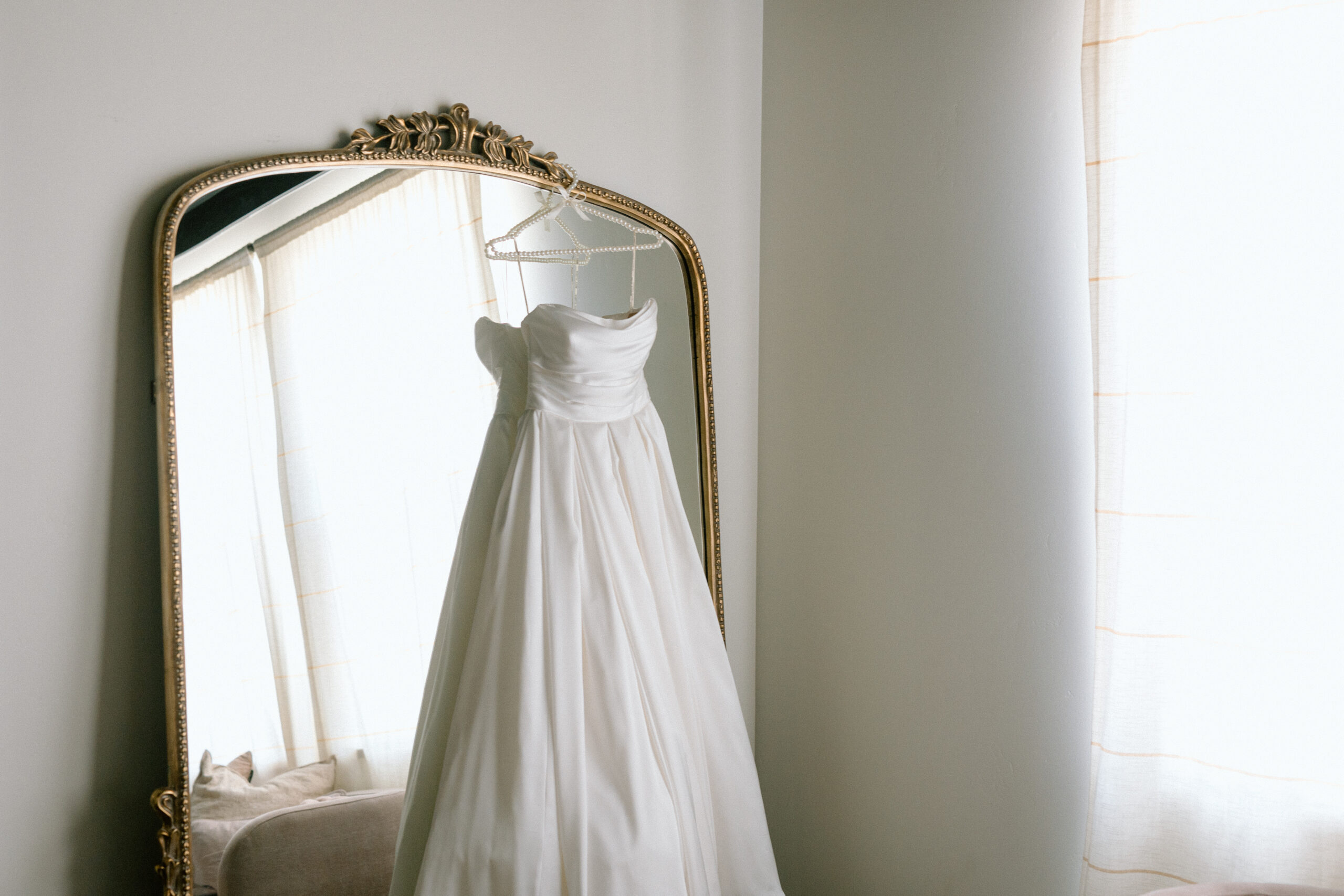 elegant Wedding dress hanging on mirror