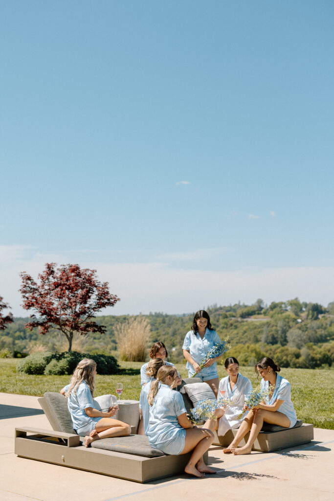 bride relaxing with her bridesmaids on her wedding day