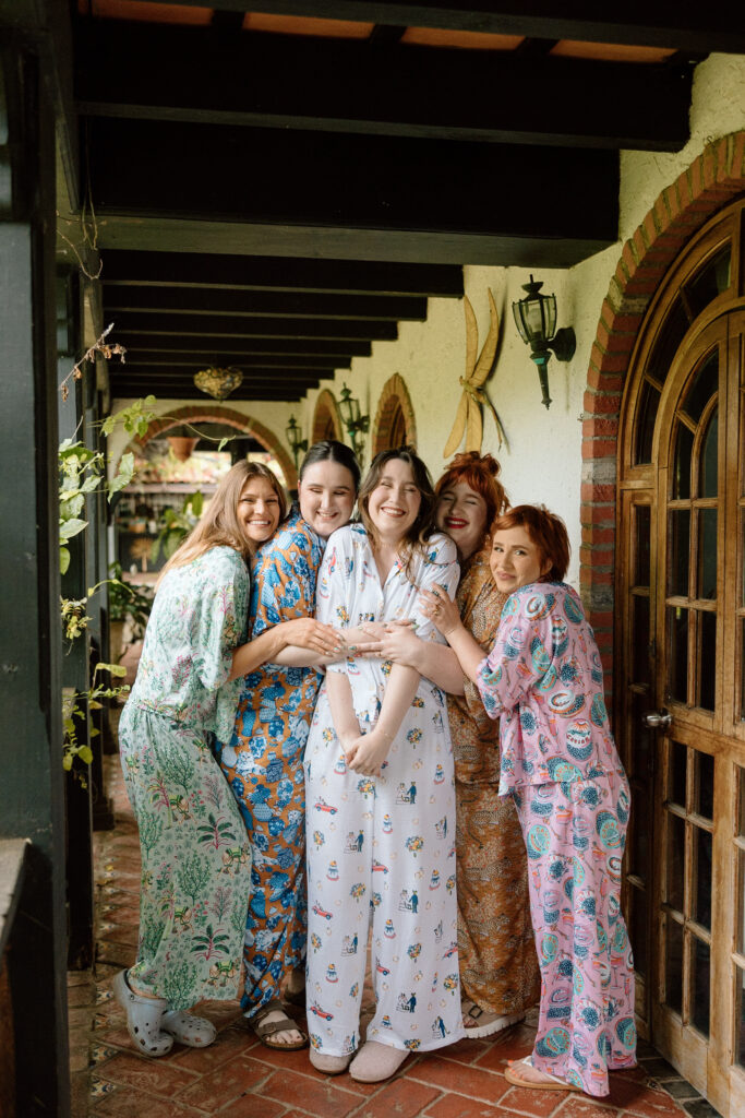 bride and bridesmaids in colorful pajamas to start the wedding day in puerto rico 