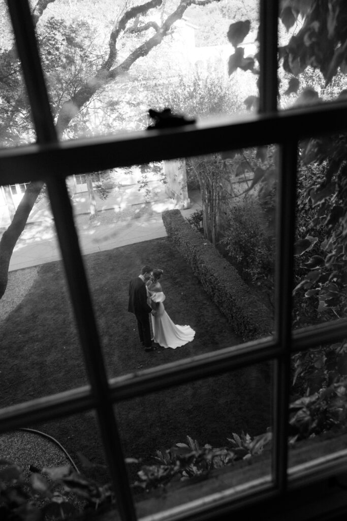 Tuscan-inspired Château St. Jean wedding venue in Sonoma Valley with arched windows, manicured gardens, and rolling vineyard views during a European-inspired California wedding.