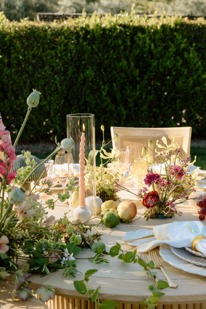  Amalfi Coast–inspired wedding tablescape at Château St. Jean featuring yellow striped linens, fresh citrus, embroidered monogram napkins, and lush floral design