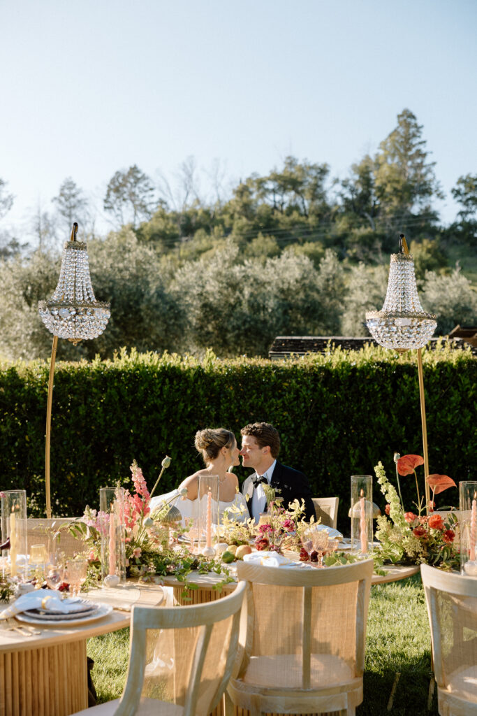Editorial wedding reception at Château St. Jean with crystal chandeliers, calla lily place cards, and a wood-and-white checkered dance floor in Sonoma Valley.