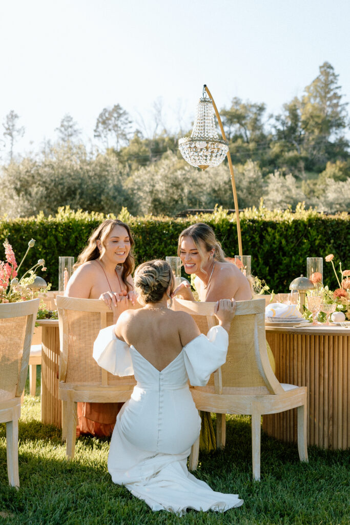 Amalfi Coast–inspired wedding tablescape at Château St. Jean featuring yellow striped linens, fresh citrus, embroidered monogram napkins, and lush floral design