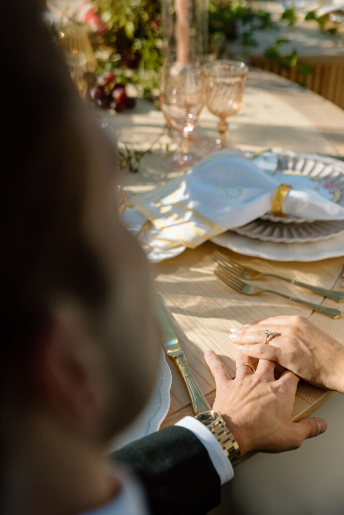 Amalfi Coast–inspired wedding tablescape at Château St. Jean featuring yellow striped linens, fresh citrus, embroidered monogram napkins, and lush floral design