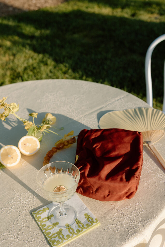 European-inspired wedding cocktail hour at Château St. Jean with citrus details, statement signage, striped linens, and a ‘ring for champagne’ moment in Sonoma Valley.