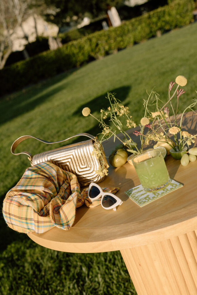 European-inspired wedding cocktail hour at Château St. Jean with citrus details, statement signage, striped linens, and a ‘ring for champagne’ moment in Sonoma Valley.