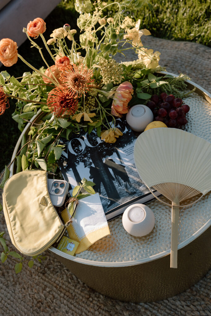 European-inspired wedding cocktail hour at Château St. Jean with citrus details, statement signage, striped linens, and a ‘ring for champagne’ moment in Sonoma Valley.