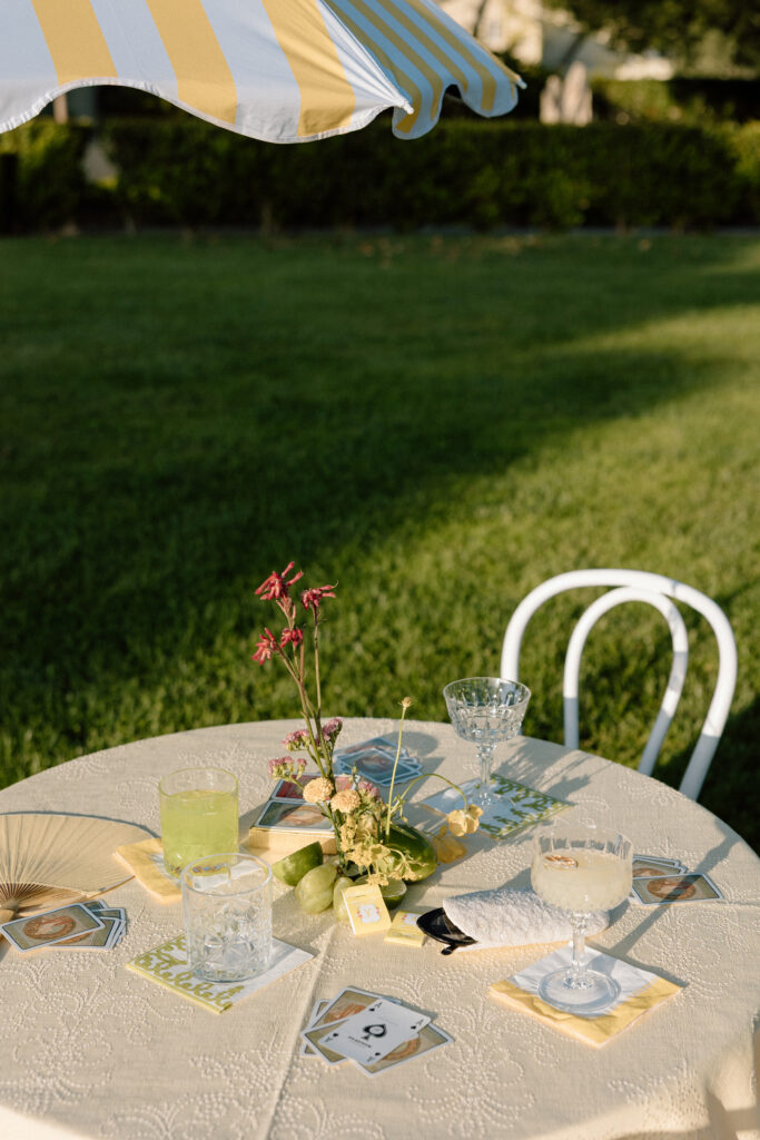 European-inspired wedding cocktail hour at Château St. Jean with citrus details, statement signage, striped linens, and a ‘ring for champagne’ moment in Sonoma Valley.