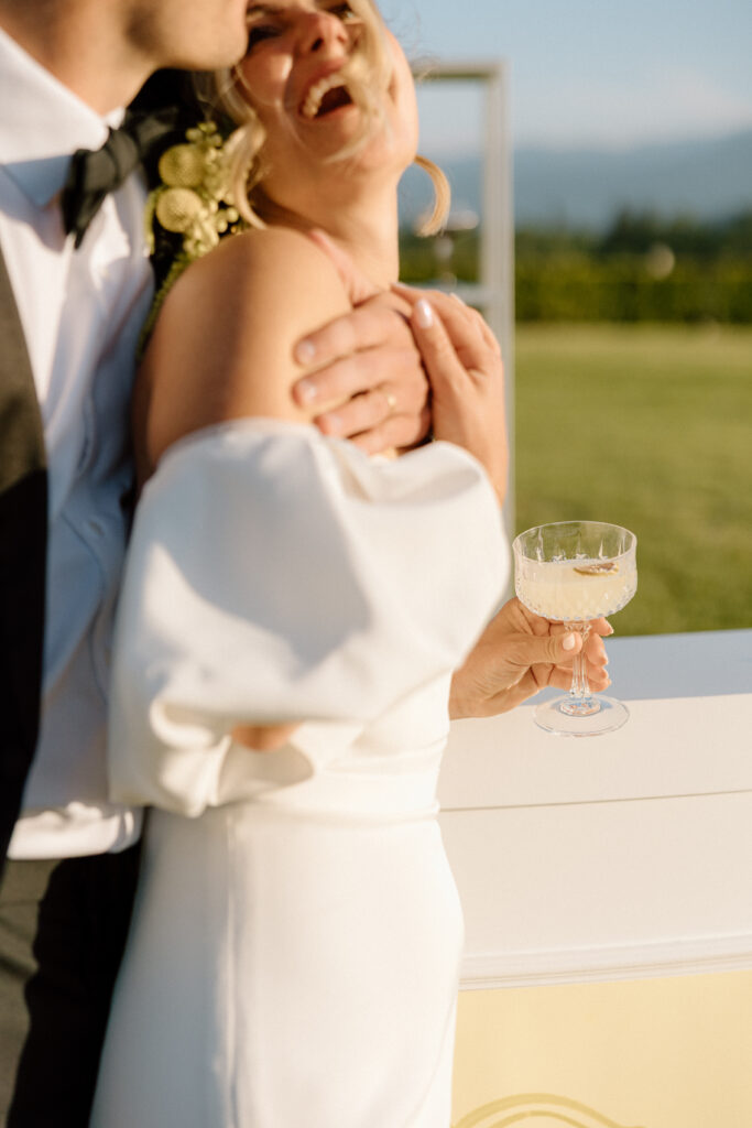 European-inspired wedding cocktail hour at Château St. Jean with citrus details, statement signage, striped linens, and a ‘ring for champagne’ moment in Sonoma Valley.