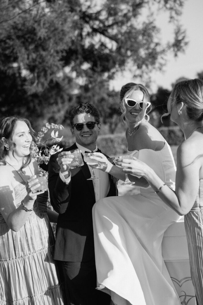 European-inspired wedding cocktail hour at Château St. Jean with citrus details, statement signage, striped linens, and a ‘ring for champagne’ moment in Sonoma Valley.