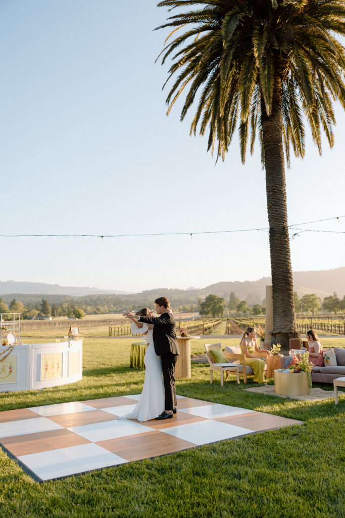 Bride and groom sharing an intimate moment at Château St. Jean in Sonoma Valley, surrounded by vineyard views during a European-inspired California wedding editorial.