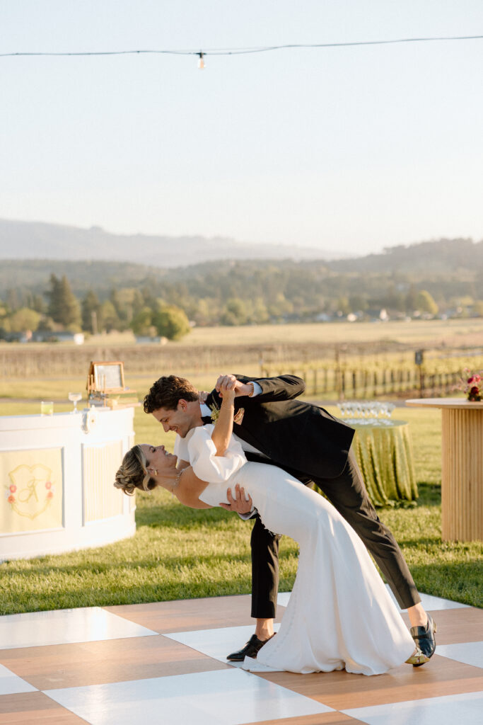 Bride and groom sharing an intimate moment at Château St. Jean in Sonoma Valley, surrounded by vineyard views during a European-inspired California wedding editorial.