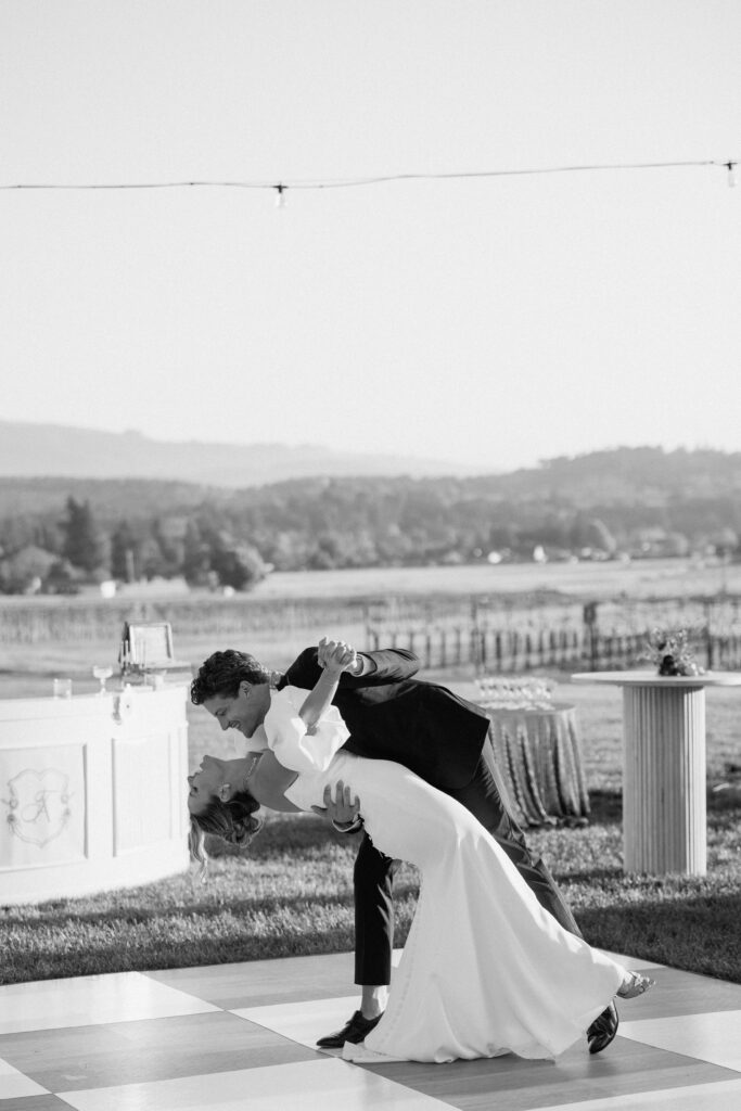 Bride and groom sharing an intimate moment at Château St. Jean in Sonoma Valley, surrounded by vineyard views during a European-inspired California wedding editorial.
