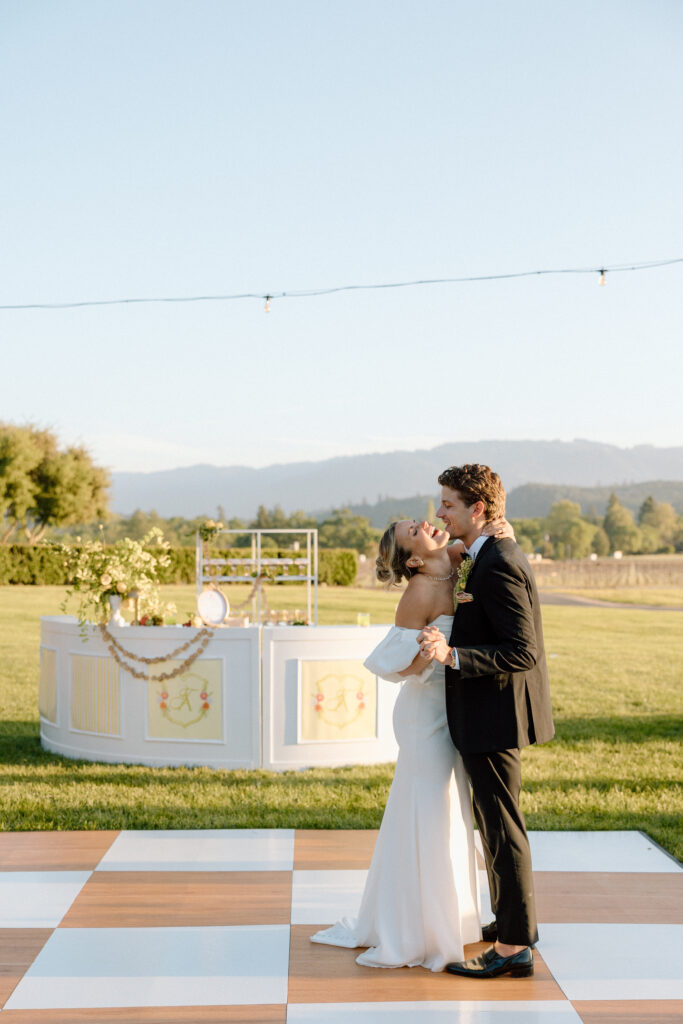 Bride and groom sharing an intimate moment at Château St. Jean in Sonoma Valley, surrounded by vineyard views during a European-inspired California wedding editorial.
