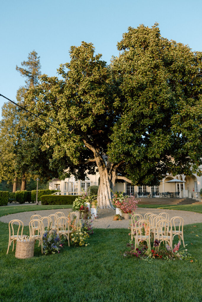Romantic outdoor wedding ceremony at Château St. Jean with flowing florals, arched architecture, and vineyard backdrops inspired by European destination weddings.