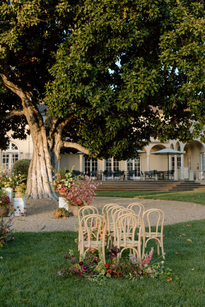 Romantic outdoor wedding ceremony at Château St. Jean with flowing florals, arched architecture, and vineyard backdrops inspired by European destination weddings.