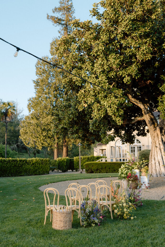Romantic outdoor wedding ceremony at Château St. Jean with flowing florals, arched architecture, and vineyard backdrops inspired by European destination weddings.