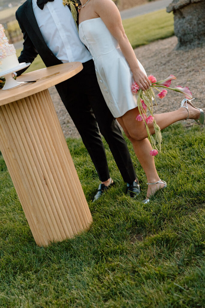Bride and groom celebrating beside an artistic wedding cake at Château St. Jean during a European-inspired California wedding reception.