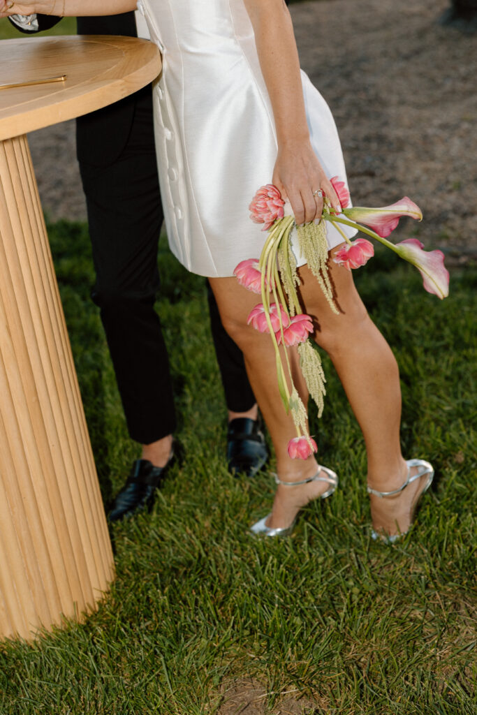 Bride and groom celebrating beside an artistic wedding cake at Château St. Jean during a European-inspired California wedding reception.