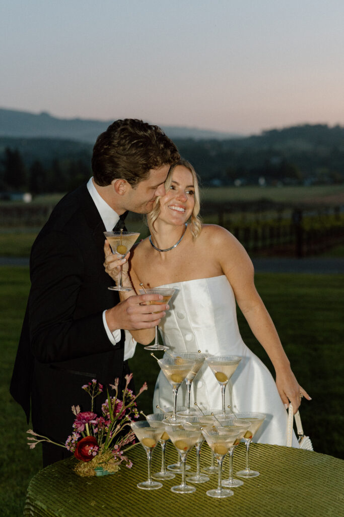 Bride wearing a modern satin mini dress and chartreuse heels during a martini tower celebration at a European-inspired California wedding at Château St. Jean.