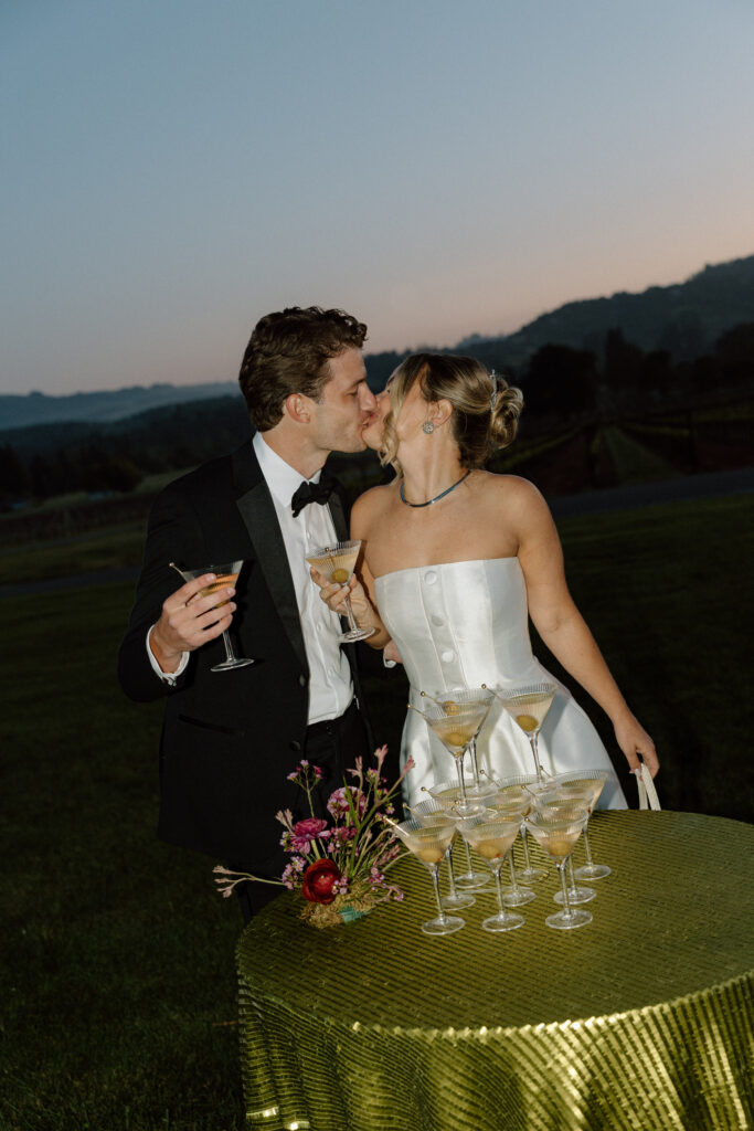 Bride wearing a modern satin mini dress and chartreuse heels during a martini tower celebration at a European-inspired California wedding at Château St. Jean.