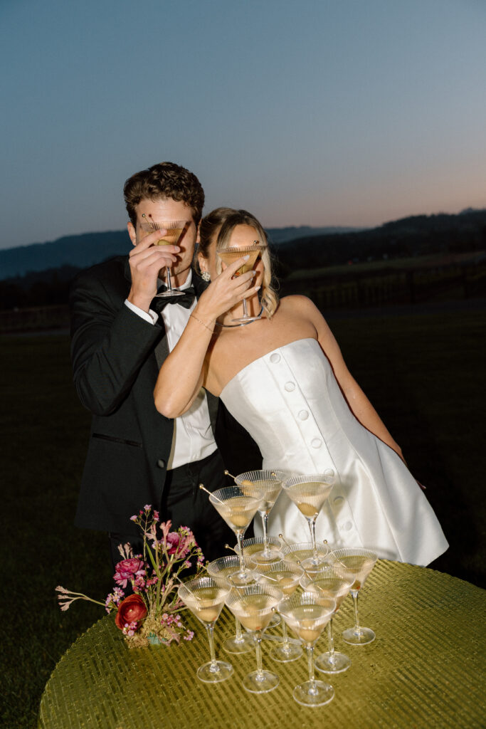 Bride wearing a modern satin mini dress and chartreuse heels during a martini tower celebration at a European-inspired California wedding at Château St. Jean.