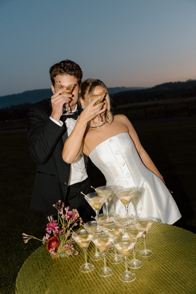Bride wearing a modern satin mini dress and chartreuse heels during a martini tower celebration at a European-inspired California wedding at Château St. Jean.
