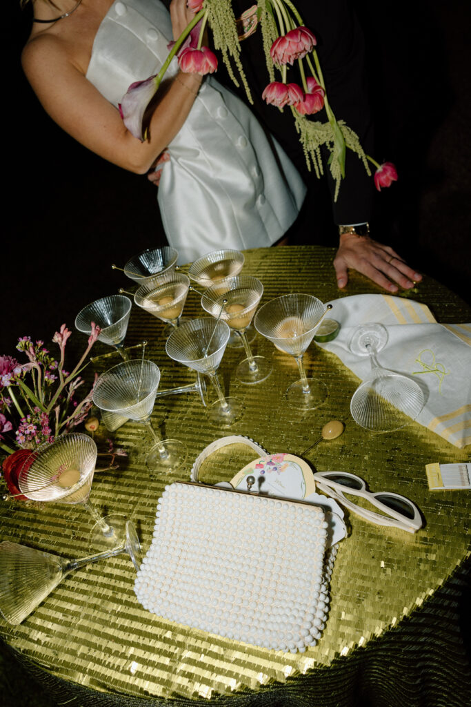 Bride wearing a modern satin mini dress and chartreuse heels during a martini tower celebration at a European-inspired California wedding at Château St. Jean.