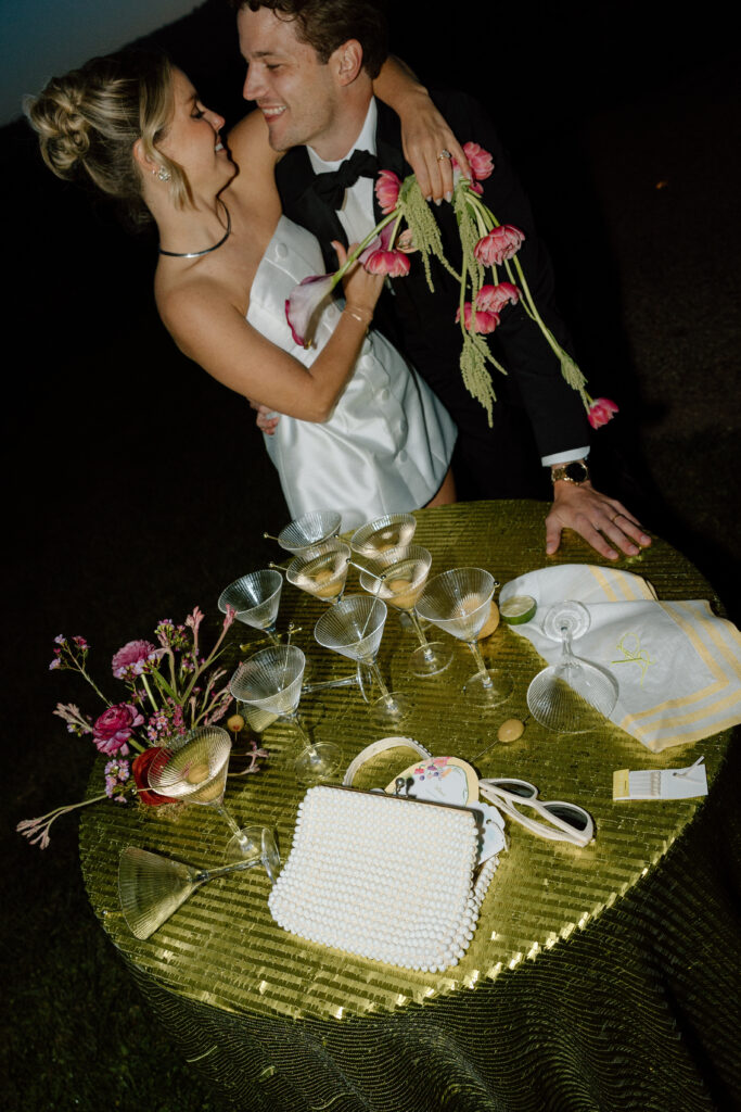 Bride wearing a modern satin mini dress and chartreuse heels during a martini tower celebration at a European-inspired California wedding at Château St. Jean.