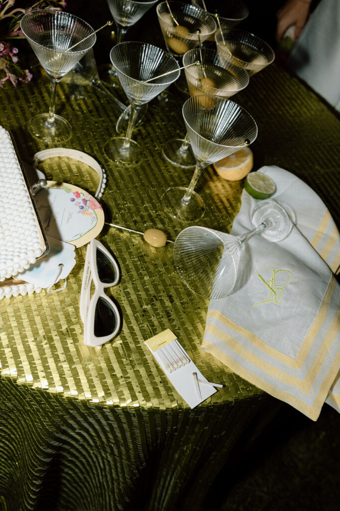 Bride wearing a modern satin mini dress and chartreuse heels during a martini tower celebration at a European-inspired California wedding at Château St. Jean.