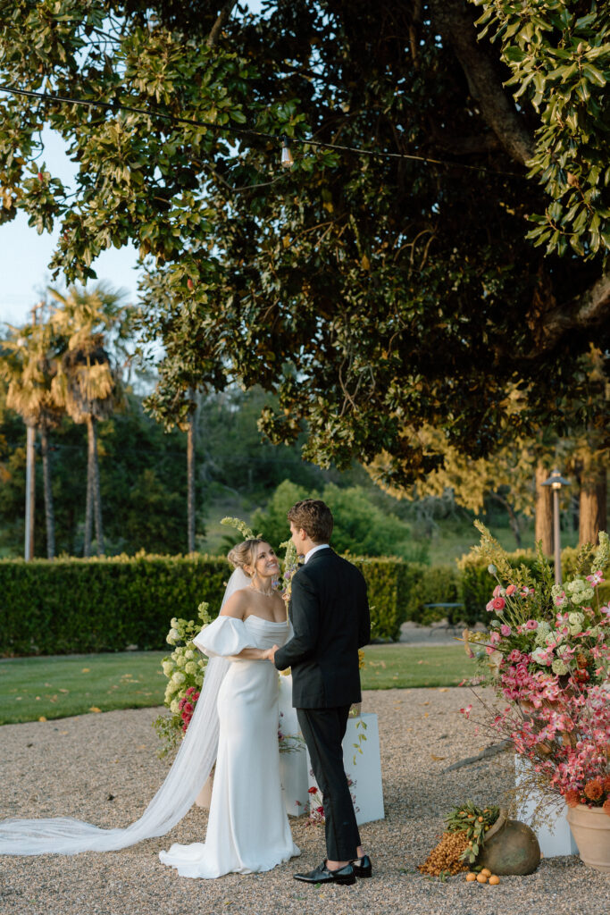 Romantic outdoor wedding ceremony at Château St. Jean with flowing florals, arched architecture, and vineyard backdrops inspired by European destination weddings.