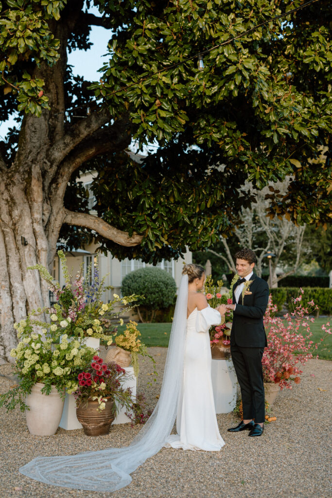 Romantic outdoor wedding ceremony at Château St. Jean with flowing florals, arched architecture, and vineyard backdrops inspired by European destination weddings.