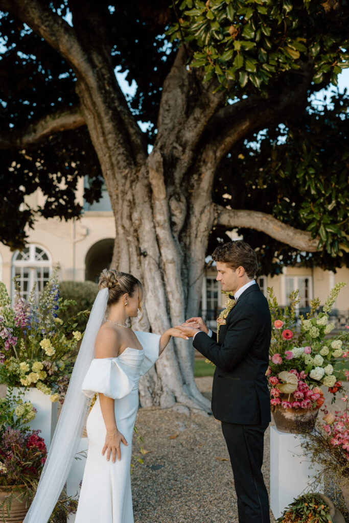 Romantic outdoor wedding ceremony at Château St. Jean with flowing florals, arched architecture, and vineyard backdrops inspired by European destination weddings.