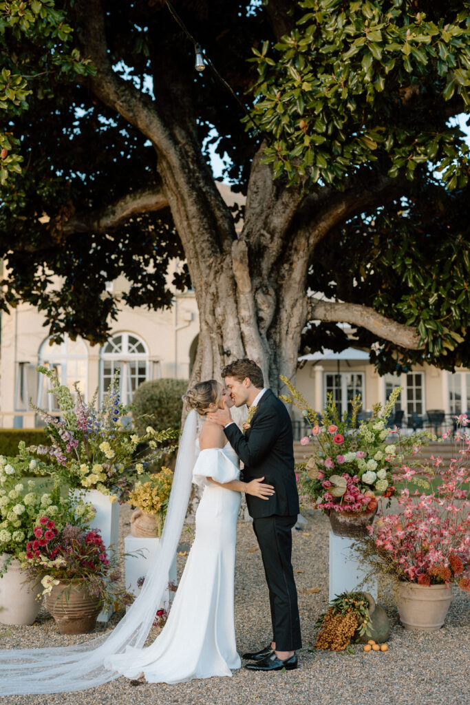 Romantic outdoor wedding ceremony at Château St. Jean with flowing florals, arched architecture, and vineyard backdrops inspired by European destination weddings.