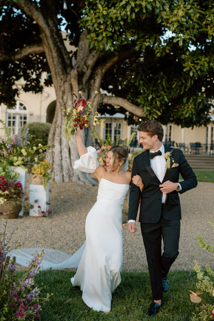 Romantic outdoor wedding ceremony at Château St. Jean with flowing florals, arched architecture, and vineyard backdrops inspired by European destination weddings.