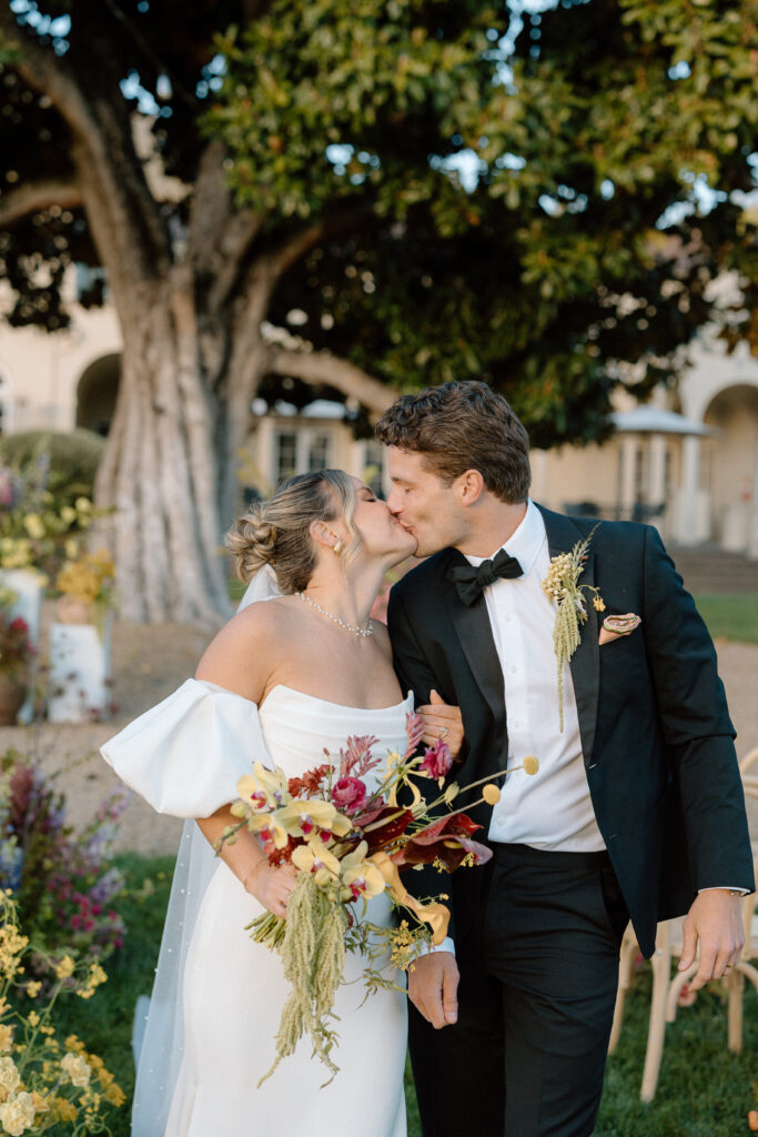 Romantic outdoor wedding ceremony at Château St. Jean with flowing florals, arched architecture, and vineyard backdrops inspired by European destination weddings.