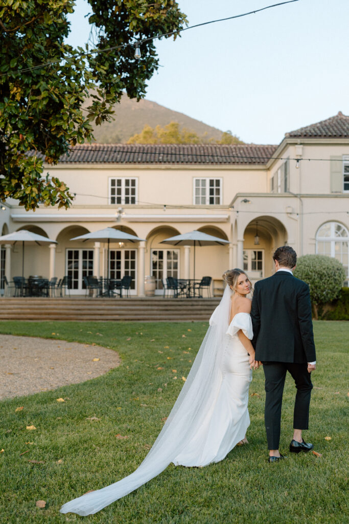 Tuscan-inspired Château St. Jean wedding venue in Sonoma Valley with arched windows, manicured gardens, and rolling vineyard views during a European-inspired California wedding.