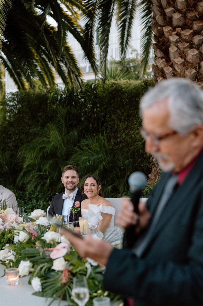 Golden hour reception beneath palm trees at a Northern California waterfront wedding