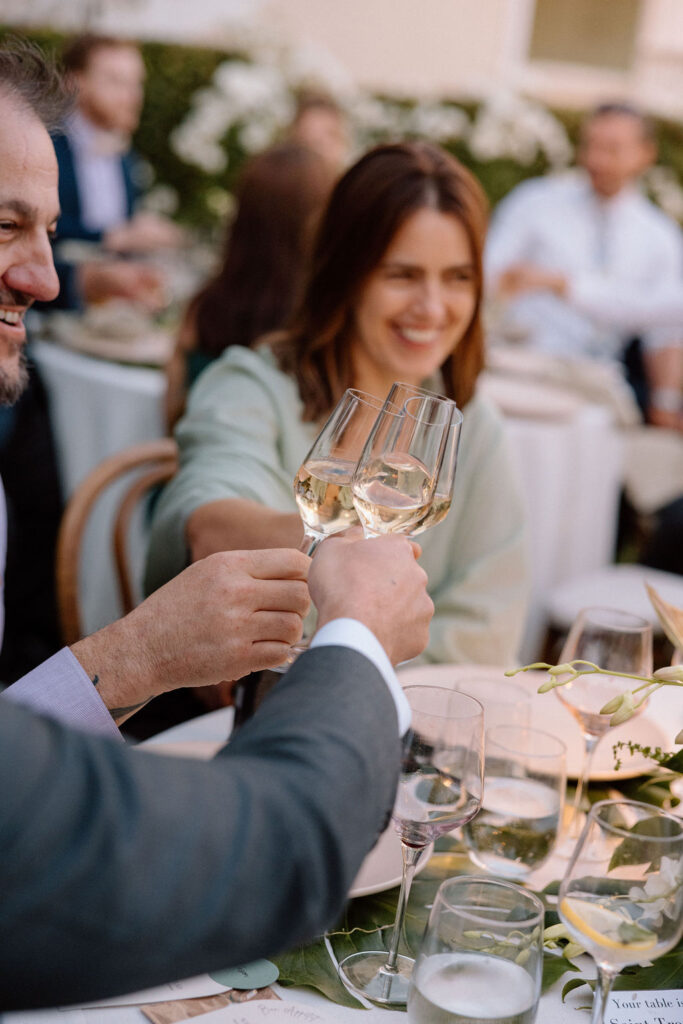 Golden hour reception beneath palm trees at a Northern California waterfront wedding