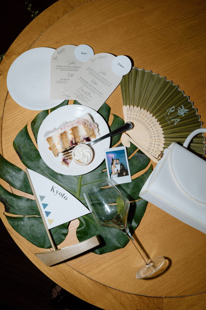 Bride and groom cutting their wedding cake inside the reception space following a sailboat ceremony exit