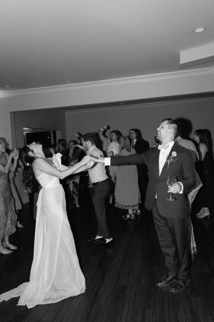 Joyful dance floor moments at a Northern California waterfront wedding reception