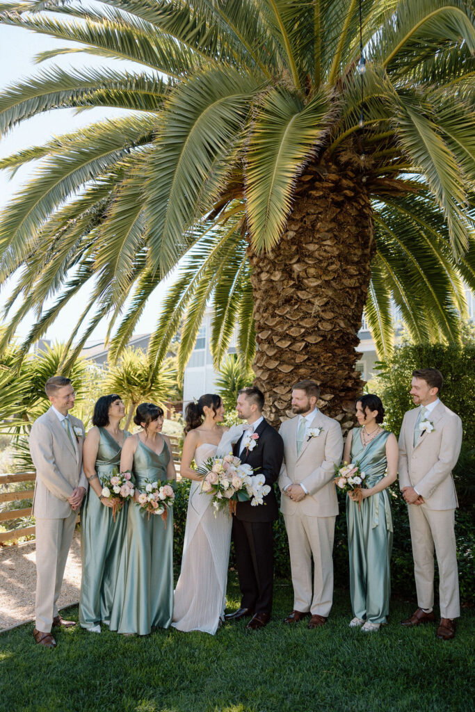 Bridal party dressed in coastal tones celebrating at a Northern California waterfront wedding