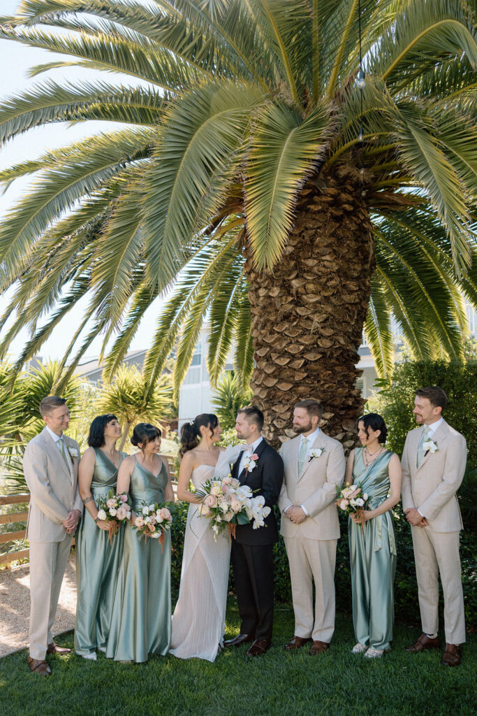 Bridal party dressed in coastal tones celebrating at a Northern California waterfront wedding