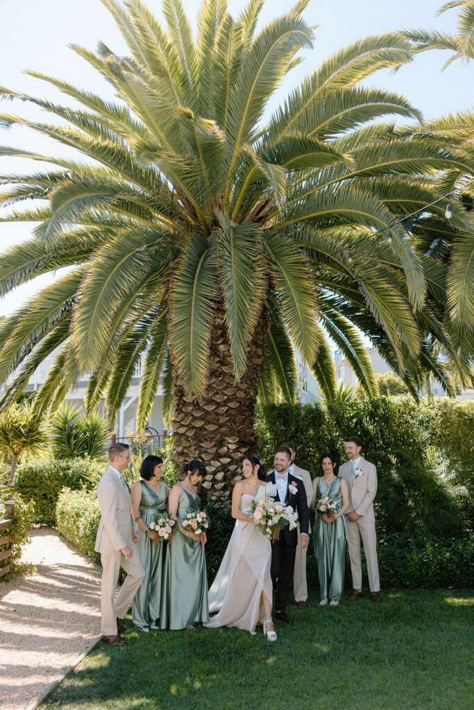 Bridal party dressed in coastal tones celebrating at a Northern California waterfront wedding